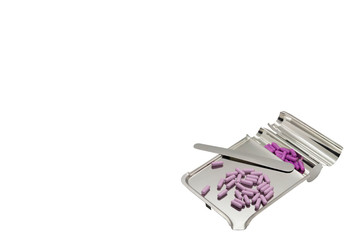 Purple pill in medicine tray on isolated white background with copy text space