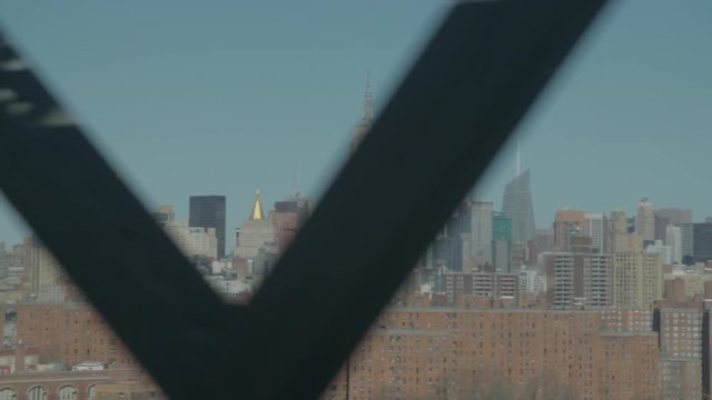 shot from the JMZ train riding the Williamsburg bridge overlooking at Manhattan and the Empire State building.