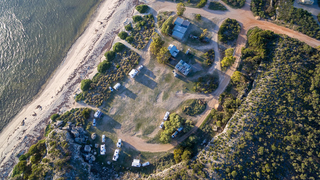 Aerial view of caravans and four wheel drive vehicles at a free camp next to the seaside in Australia