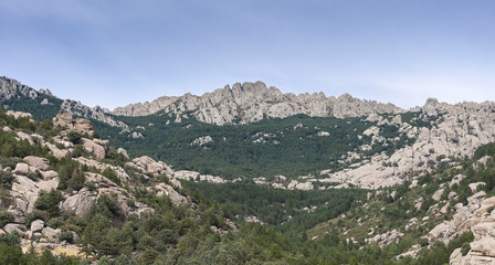 Fototapeta na wymiar Views of La Pedriza from the Giner de los Rios refuge, in Guadarrama Mountains, Madrid, Spain. It can be seen Las Torres (The Towers), Las Buitreras (Vulture) and El Pajaro (The Bird) peaks