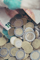 Euro coins scattered from the bag. The concept of saving money. Shallow depth of field.