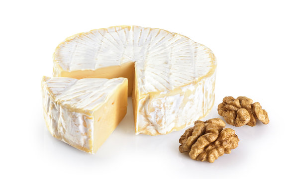 Camembert cheese and walnuts isolated on white background.