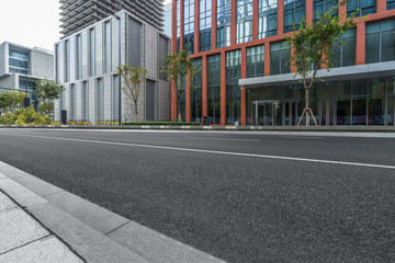 Fototapeta na wymiar empty road and modern office buildings.