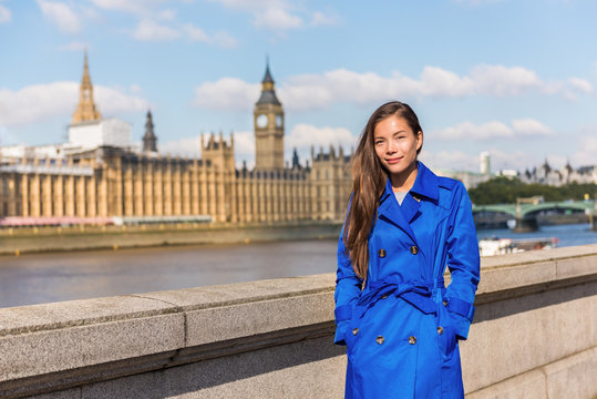 London city Europe lifestyle Asian business woman businesswoman in autumn travel holiday. Chinese businesswoman girl in stylish fall trench coat at Westminster and Big Ben.