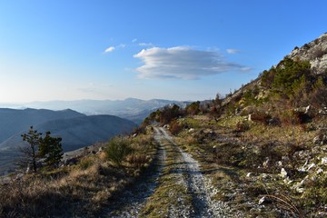 Fototapeta na wymiar Narrow high path on dry rocky mountain. Beautiful scenery landscape.