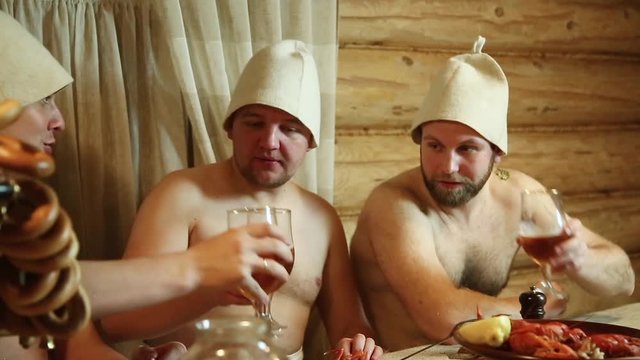 men drink beer in the bath