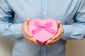 man holding a gift box in the form of heart 