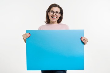 Smiling middle aged woman with blue sheet billboard