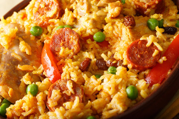 Arroz Valenciana with meat, chorizo, vegetables and spices close up in a bowl. horizontal