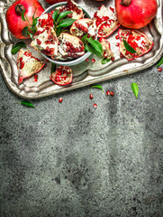 Ripe pomegranates on a steel tray.