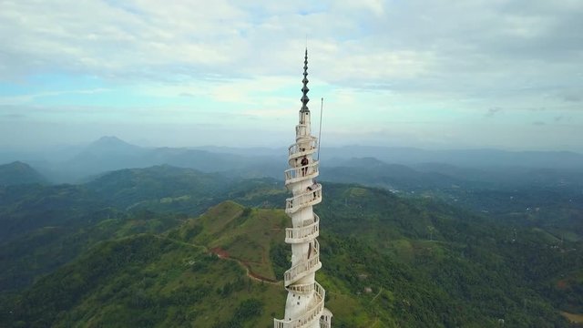 Funny couple on Ambuluwawa tower on the top of hill at sunrise drone footage