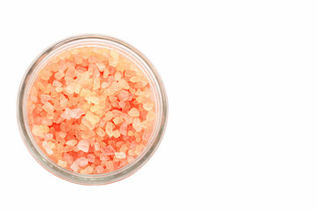 Big Crystals of pink Himalayan salt in jar. White background. Top view.