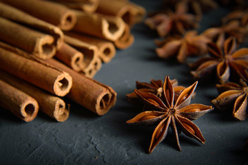 shelves of cinnamon and anise stars in dark colors on a dark concrete stone background