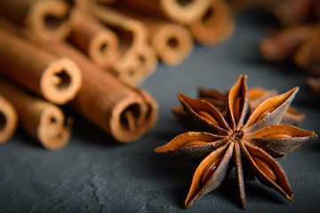  shelves of cinnamon and anise stars in dark colors on a dark concrete stone background