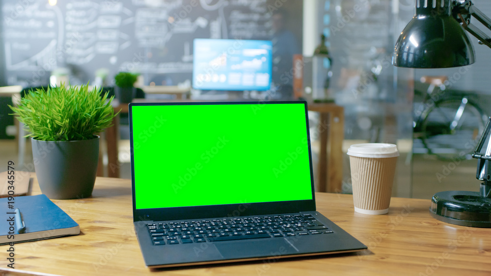 Aufkleber personal computer with mock-up green screen monitor stands on the office desk. in the background sty