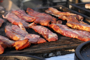 Grilling raw meat. Raw meat prepared on a grill. Fast food outside.  