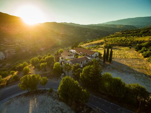 Aerial bird's eye view of Holy monastery of Archangel Michael (Archangelou Michail) in Monagri village, Limassol, Cyprus, an ancient christian religious monument, at sunset flare, from above.