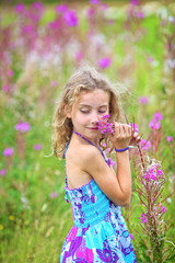 adorable girl enjoys life and gathers wildflowers