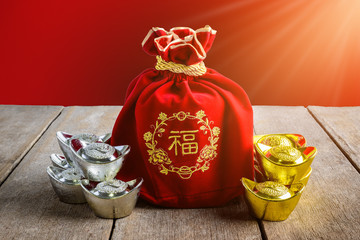 Chinese New Year Red fabric bag, ang pow with Chinese money of luck and Shoe-shaped gold ingot