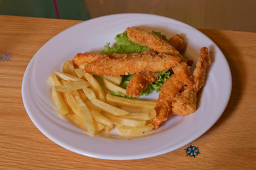 Chicken nectar with potato free . Chicken steak and potatoes on a wooden background. Top view. Free space for text.