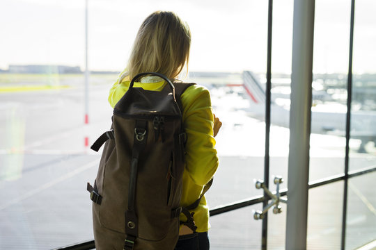 Woman with backpack walking in airport