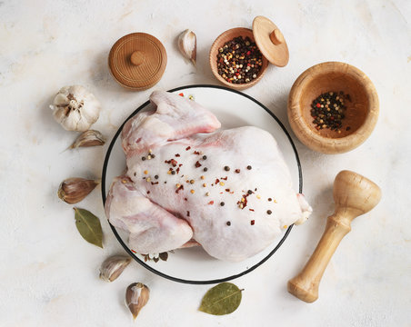 chicken with seasonings on a light background