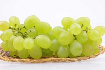 Grapes are in the basket isolated on a white background