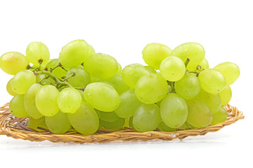 Grapes are in the basket isolated on a white background