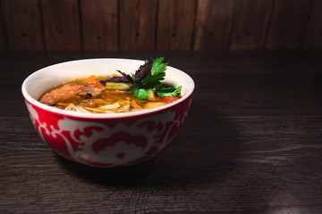 A plate of hot oriental soup with meat and noodles