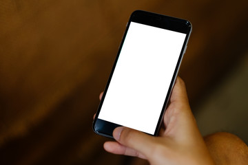 Close up of man using mobile smart phone,sending massages on the garden.having sunbath.Phone with black screen,texting,video calls,