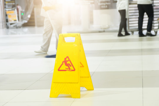 Sign showing warning of caution wet floor at airport.
