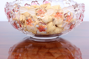 Cookies in a glass plate on a wooden table