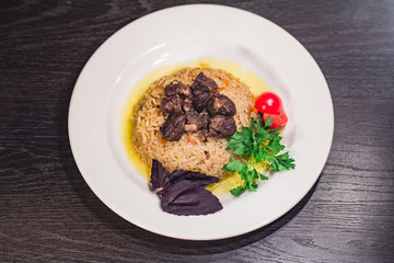 Delicious hot pilaf with meat, rice on oriental