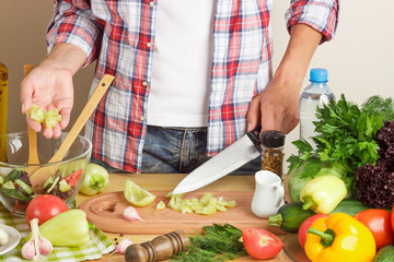 Woman is cooking at the kitchen