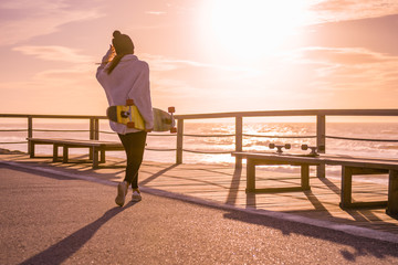 Girl holding a skateboard