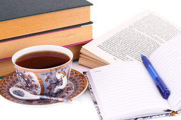 Books, cup of tea and pen