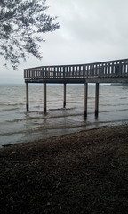 Obraz premium Holzsteg am Chiemsee in Chieming im düsteren Herbst