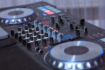 professional music equipment for playing and control music in nightclub with hands DJ . Dj mixes...