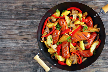 grilled sausages with potato wedges, mushrooms