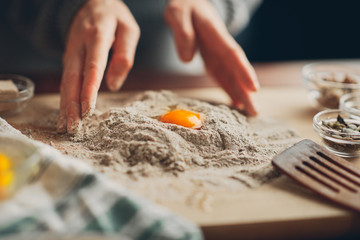 Close up of woman`s hands making a bread.