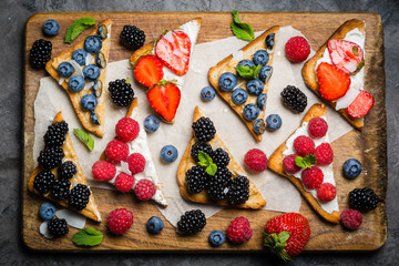 Selection of toasts with cheese peanut butter and berries