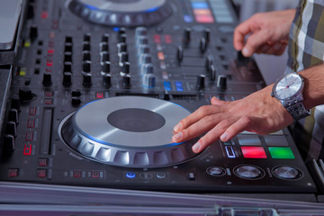 professional music equipment for playing and control music in nightclub with hands DJ . Dj mixes...