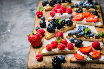 Selection of toasts with cheese peanut butter and berries