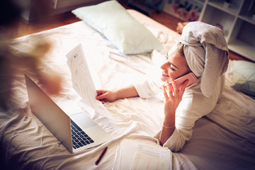 Working from bed. Morning in business woman life.