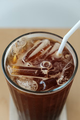 Iced black coffee in cup, close up