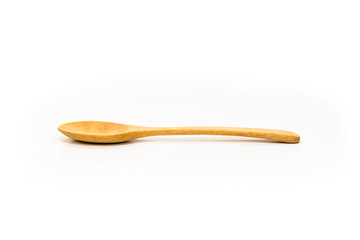 Spoon made of wood laid on white floor.