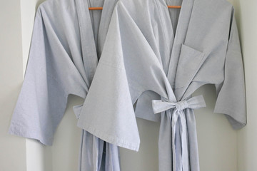 Bathrobes hang together, In the bedroom of the couple with a warm atmosphere.