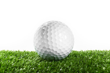 White golf ball on green lawn.
