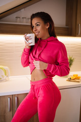 Young fit girl sipping the coffee.