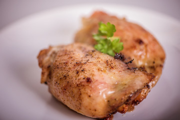 roasted chicken tights on white plate 